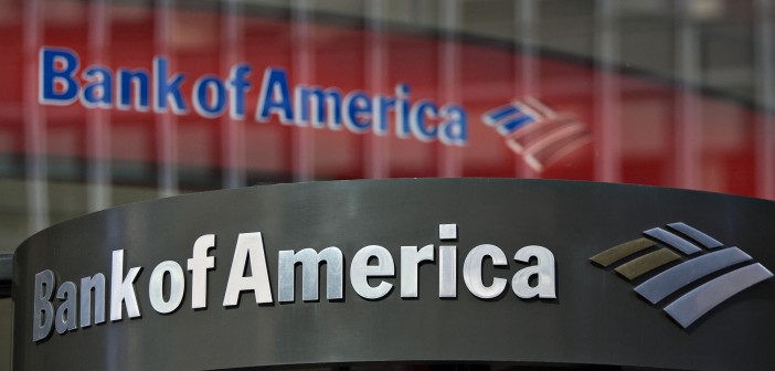 A Bank of America logo hangs above a bank branch entrance in