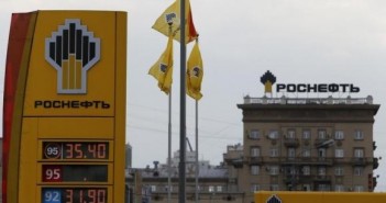 The logo of Russia's top crude producer Rosneft is seen on a price information board of a gasoline station in Moscow