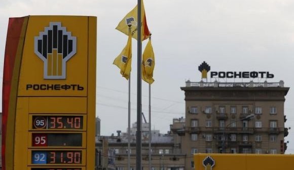 The logo of Russia's top crude producer Rosneft is seen on a price information board of a gasoline station in Moscow