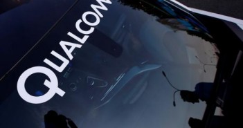 A logo of U.S. chipmaker Qualcomm is seen on the windshield of a car in Beijing