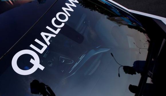 A logo of U.S. chipmaker Qualcomm is seen on the windshield of a car in Beijing