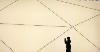 A woman takes a picture outside the Samsung stand at the Mobile World Congress in Barcelona