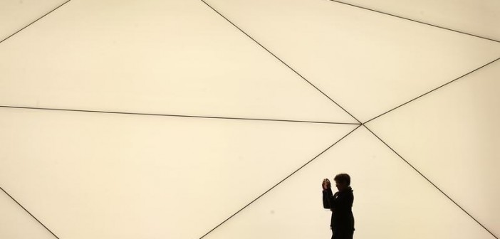 A woman takes a picture outside the Samsung stand at the Mobile World Congress in Barcelona